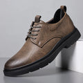 Men's black and brown leather casual sneakers with sewing line detail on the upper.