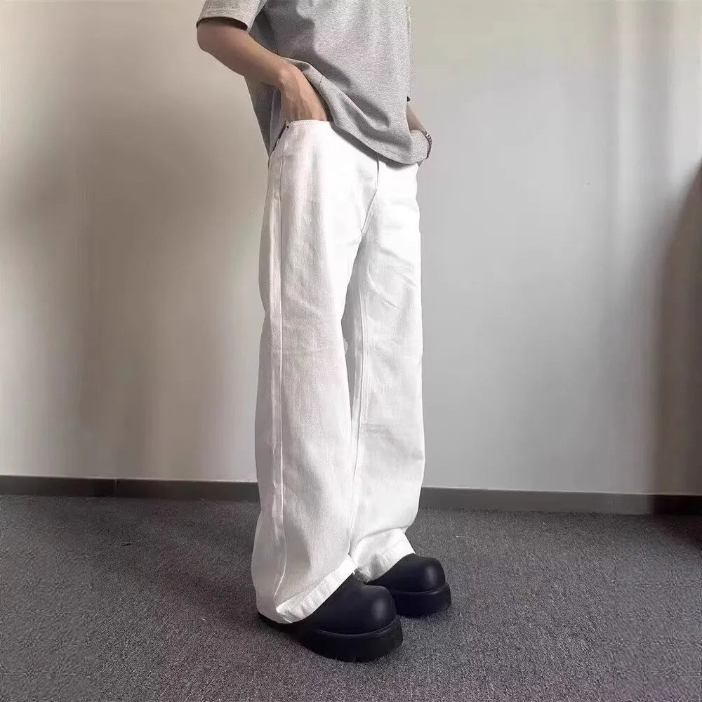 Men's white straight leg jeans with mid-waist zipper fly and loose wide leg cotton denim design