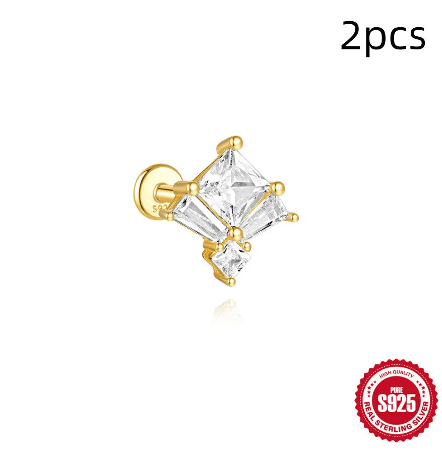 S925 sterling silver stud earrings with zircon inlay in golden geometric designs including clover and crown.