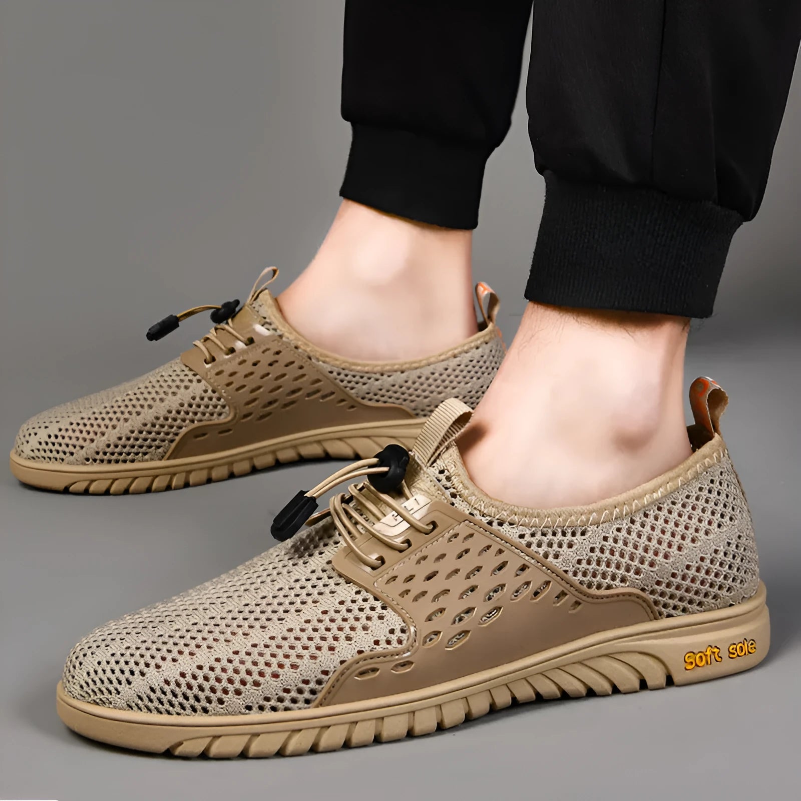Men's black breathable mesh casual shoes with elastic band fastening and flat rubber sole