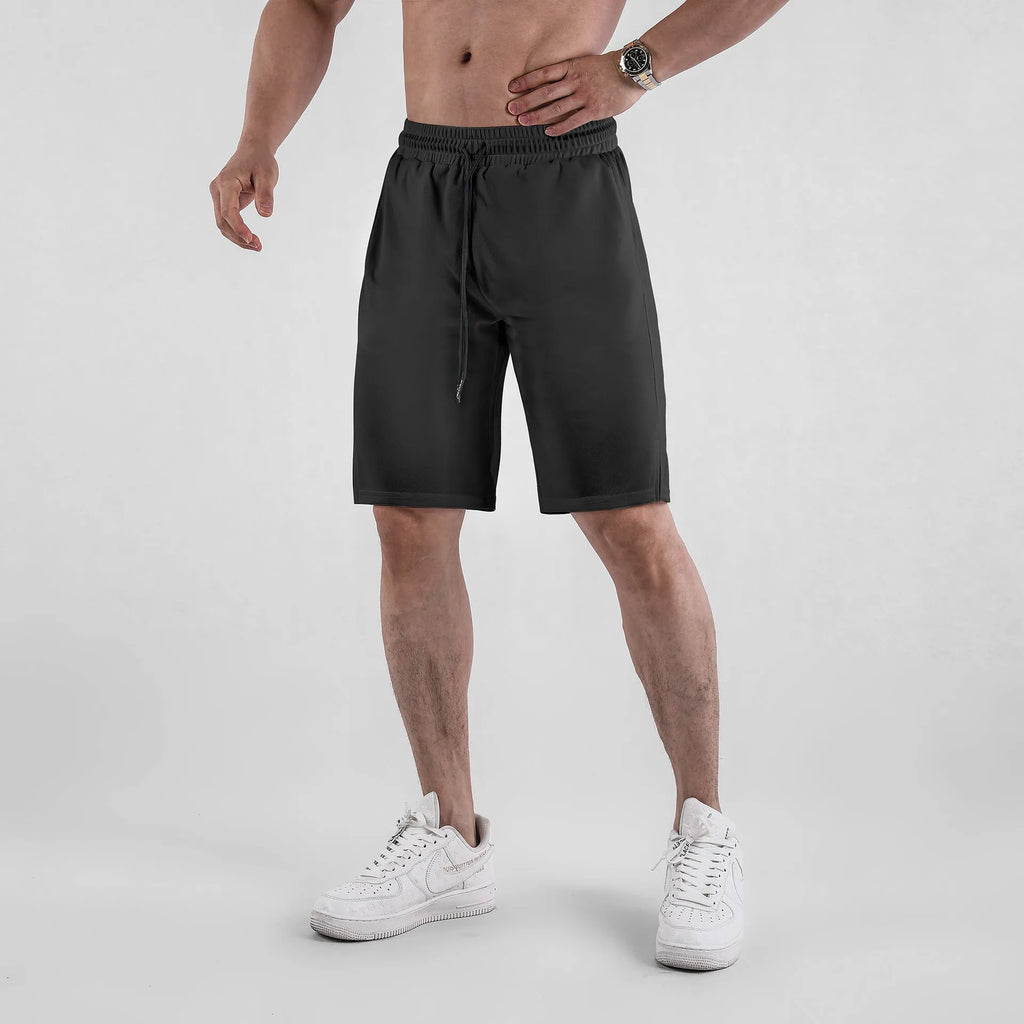 Men's quick-drying mesh shorts in black or white with elastic waist and loose casual fit for summer wear