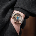 Men's stainless steel mechanical watch with round dial, transparent case back, and butterfly buckle