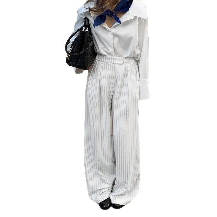 White striped wide-leg casual trousers with a front zip closure, shown in a loose fit.