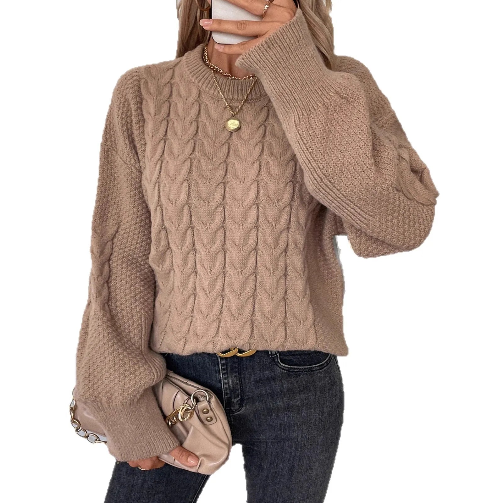 Women's loose beige round neck sweater showing twisted texture detail on the front.