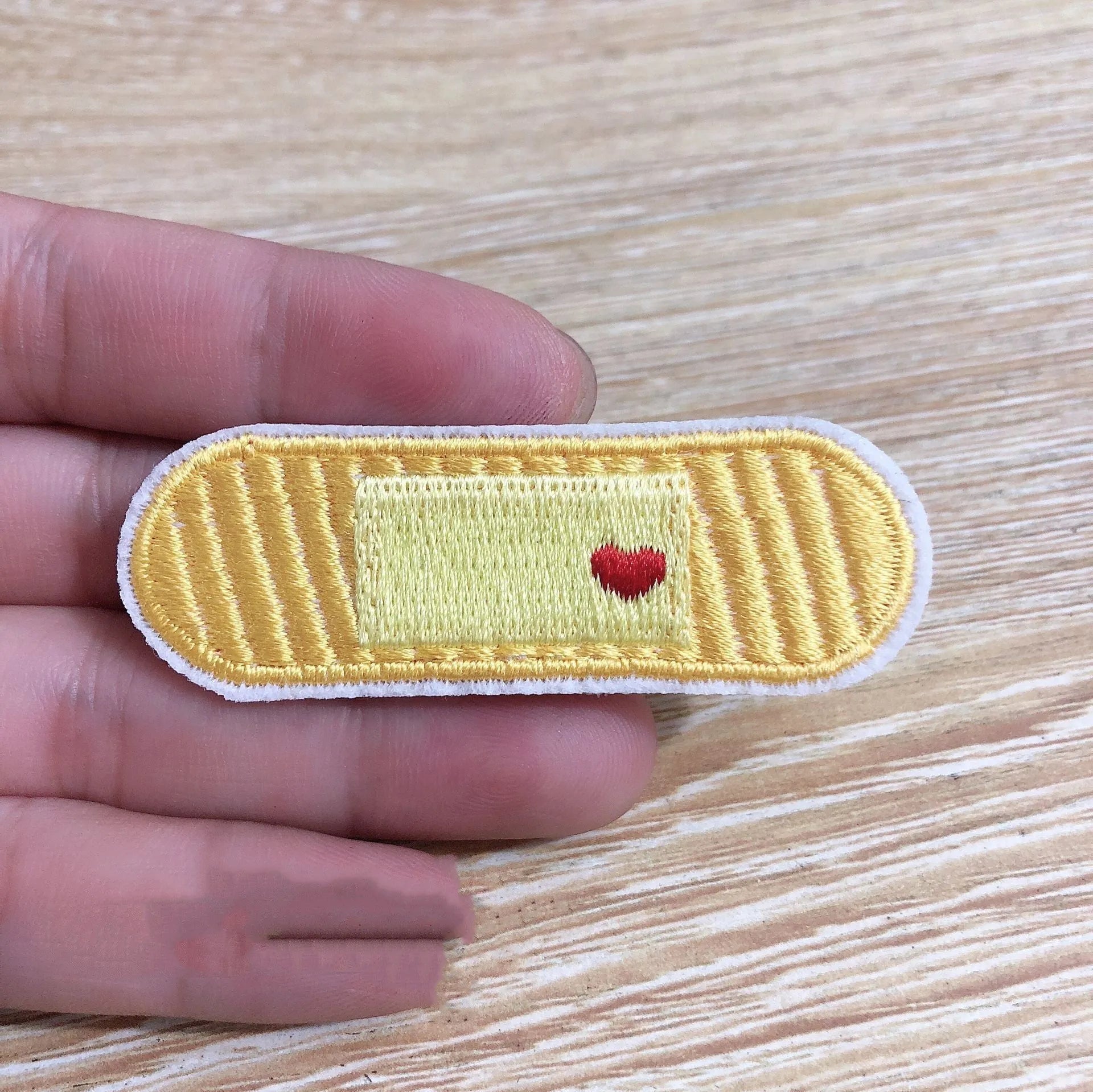 Pack of ten embroidered iron-on cloth patch badges for clothing and craft customisation.