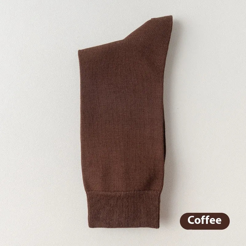 Mid-calf men's socks in solid colours made from combed cotton, shown in a stack.