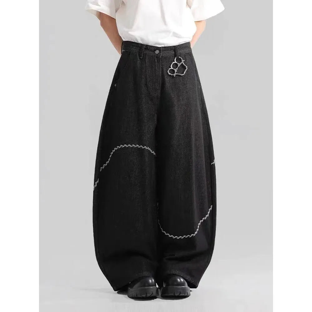 Black straight-leg denim trousers for teenagers on a hanger, showing mid-waist and zip fly detail.