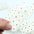 Small-scale simulated toilet paper roll model made of paper, shown next to a ruler for scale.