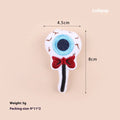 Small plush cat teaser toy with candy, eyes and skull attachments on lightweight handle
