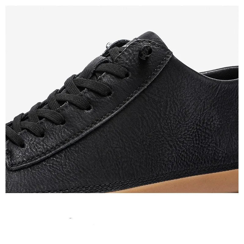 Men's black leather casual shoes with white stitching and lace closure on a white rubber sole