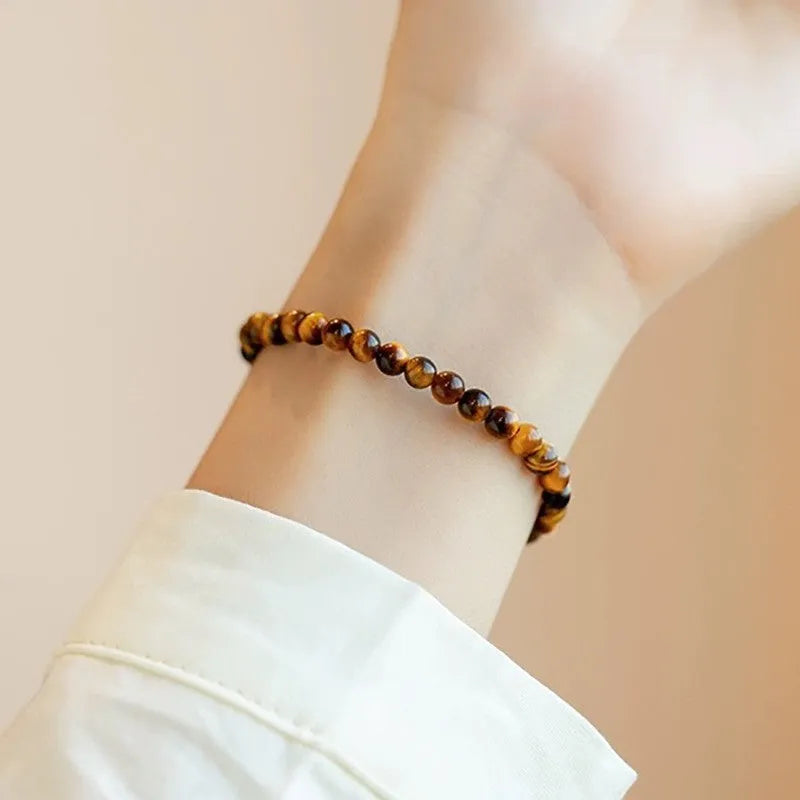 Natural tigereye gemstone bead bracelet in New Chinese geometric style on a wrist.