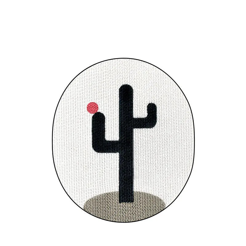Wall-mounted corrugated cardboard cat scratcher with a decorative design on a wall.