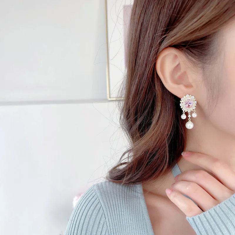 Oval zircon inlaid pearl tassel earrings in copper with geometric design and dangling elements
