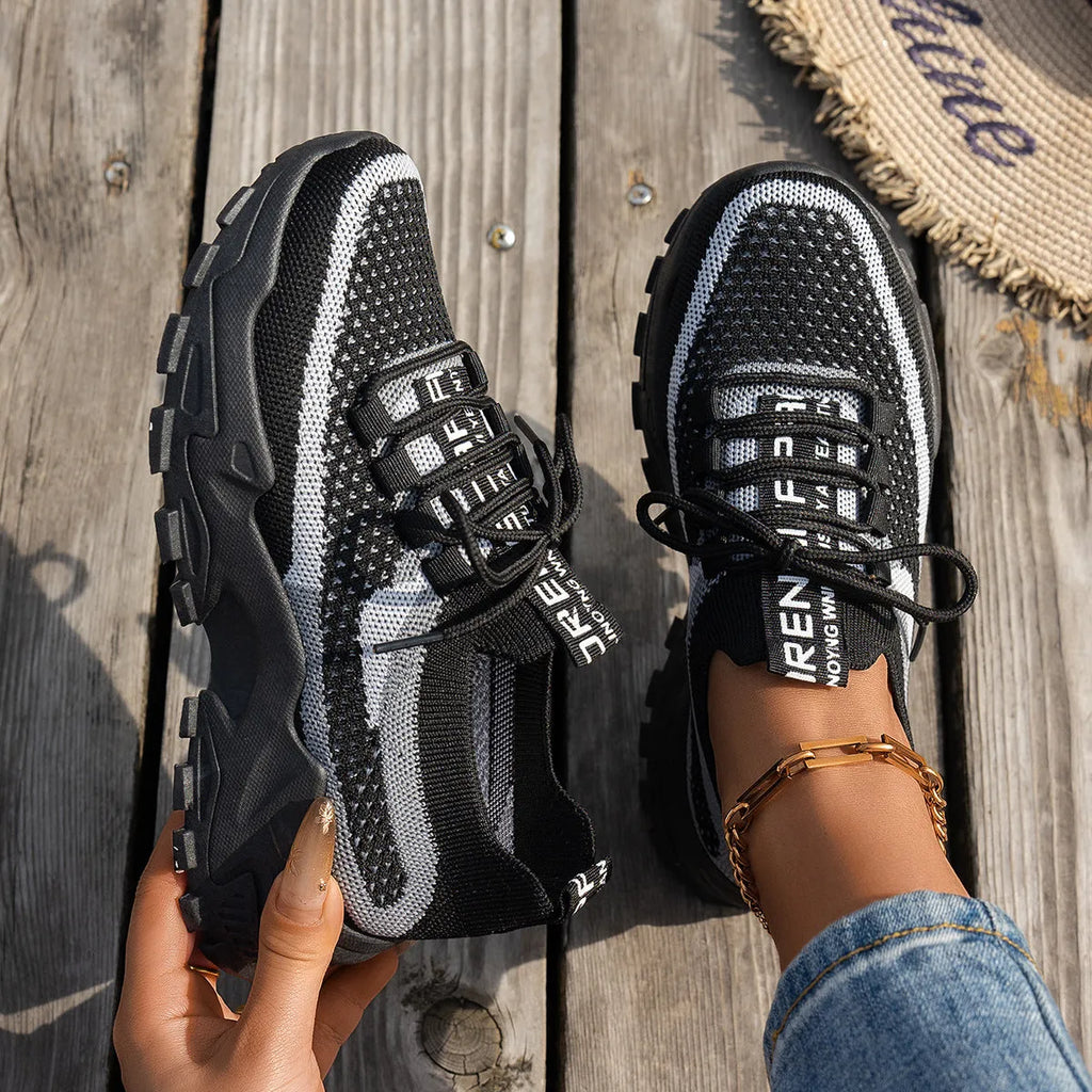 Women's Flyknit lace-up sneakers in a selected colour with a low rubber sole and round toe