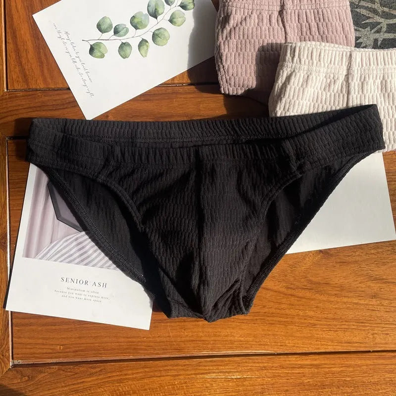 Men's solid colour cotton briefs with a mid waist and triangle design.