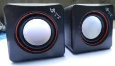 Small black square USB-powered computer speaker for desktop audio enhancement
