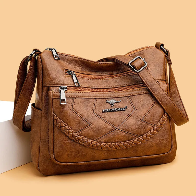 Soft PU leather shoulder bag in horizontal square shape, shown in one of four colours with crossbody strap