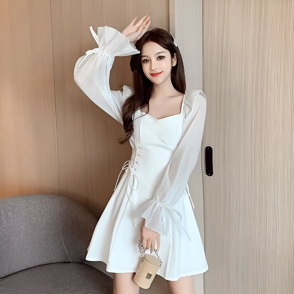 White women's chiffon dress with patchwork detail, long sleeves, and a waist-slimming long skirt.