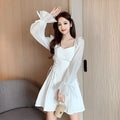 White women's chiffon dress with patchwork detail, long sleeves, and a waist-slimming long skirt.