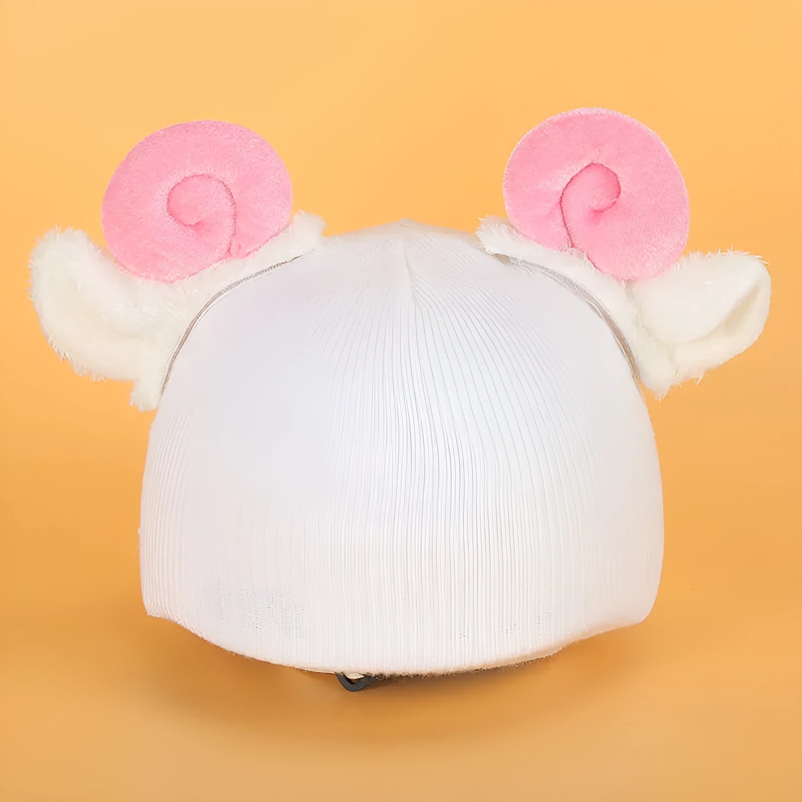 A plush fabric cartoon character helmet hat cover with attached ears on a white background.