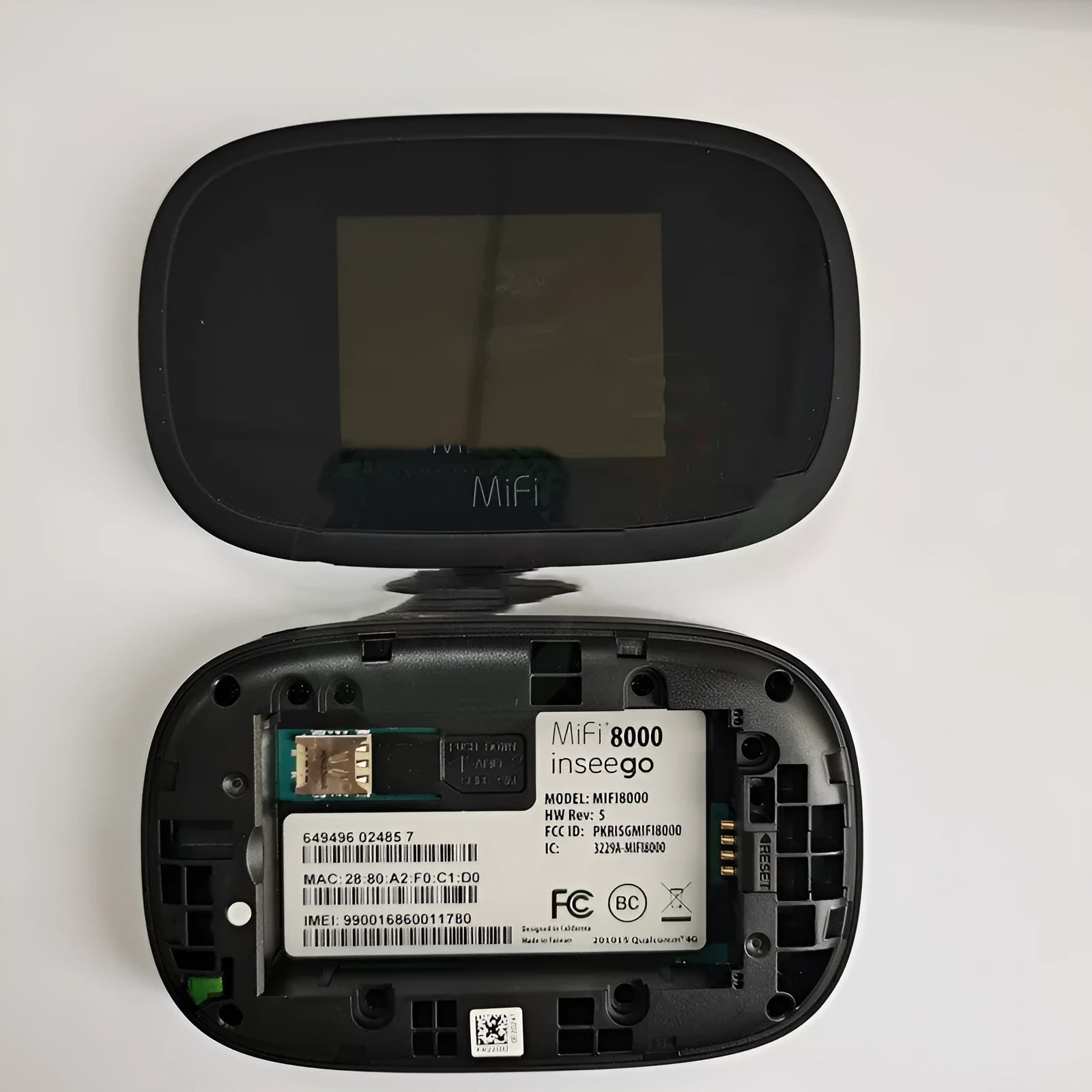 Black mifi8000 4G portable wireless router with battery and data cable on a white background.