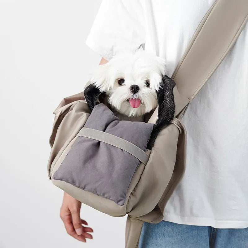 Apricot coloured cloth pet handbag for outdoor summer use.