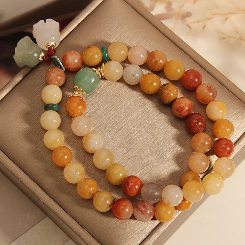Natural green jinsi jade multi-layer bracelet for women with an orchid pendant charm on an elastic band.
