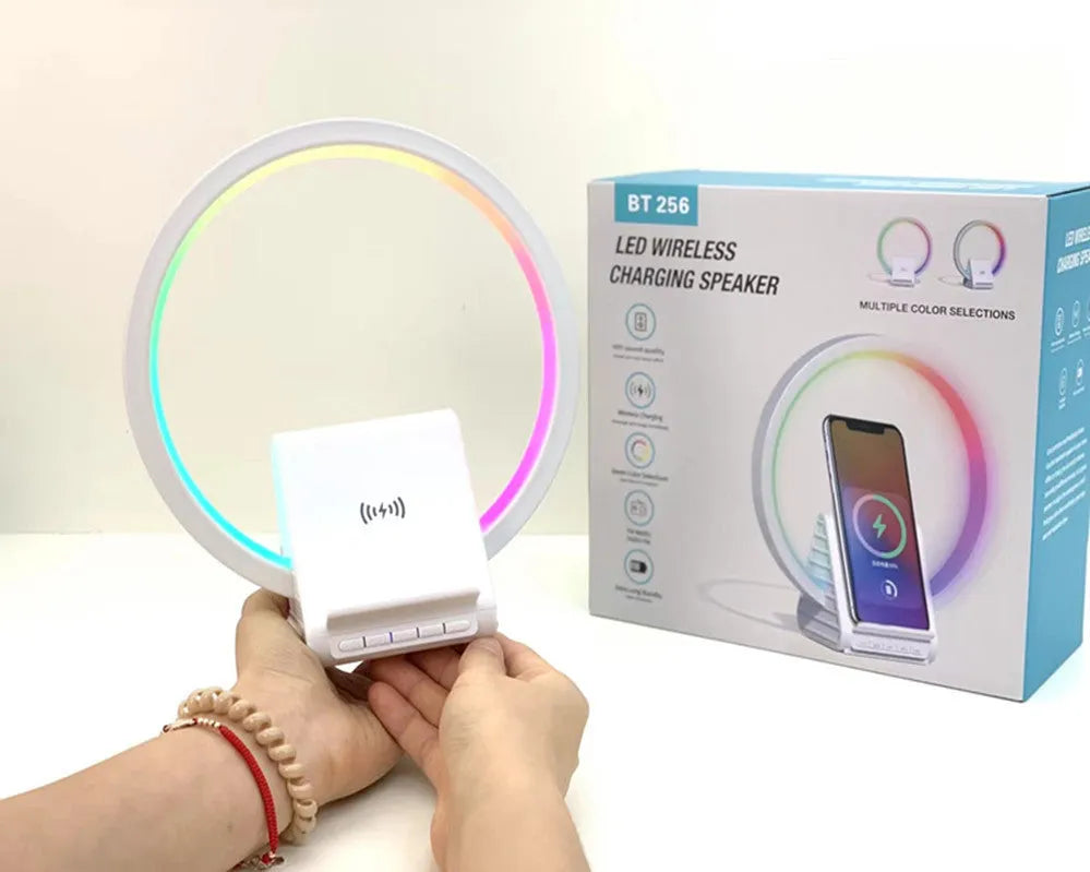 White Bluetooth speaker with wireless charging surface and ambient lighting