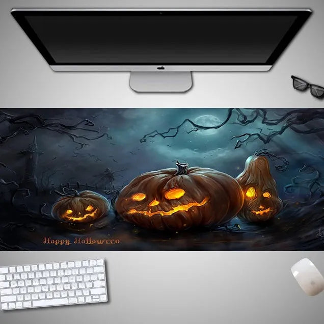 Oversized Halloween-themed computer mouse pad with non-slip rubber cloth base on a desk