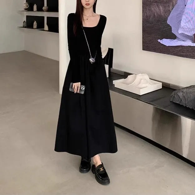 Women's black knitted dress with square collar and elastic waistband showing A-line long skirt design