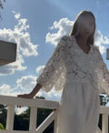 Women's loose V-neck cardigan with a large three-dimensional lace flower on hollow lace fabric.