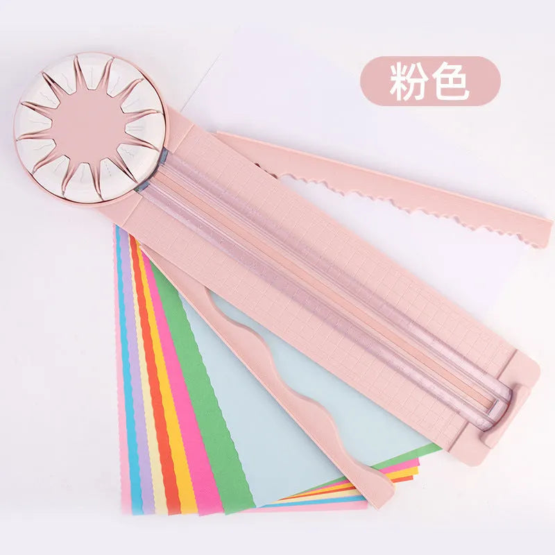 Pink 12-in-1 dotted line paper cutting machine on desktop for card making and scrapbooking