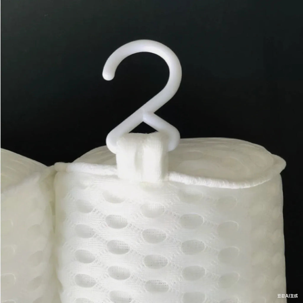 White bathtub pillow with 4D mesh fabric and suction cups on a flat surface.