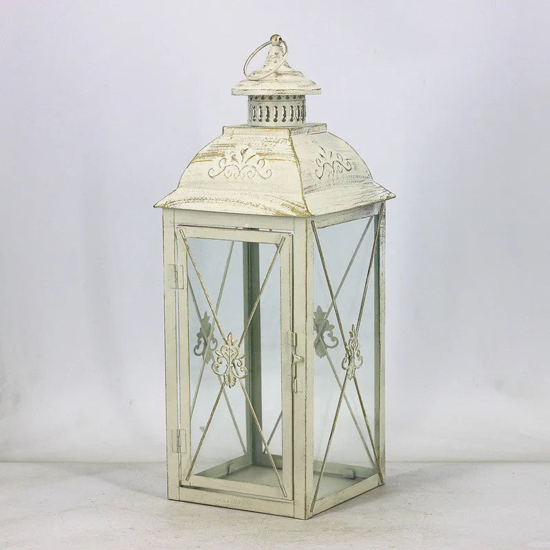 Black and white wrought iron floor-standing storm lantern with tempered glass panels for courtyard use