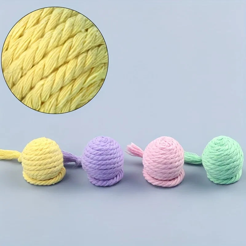 Interactive cat toy ball with rope attachment and built-in bell in green, pink, purple and yellow colours