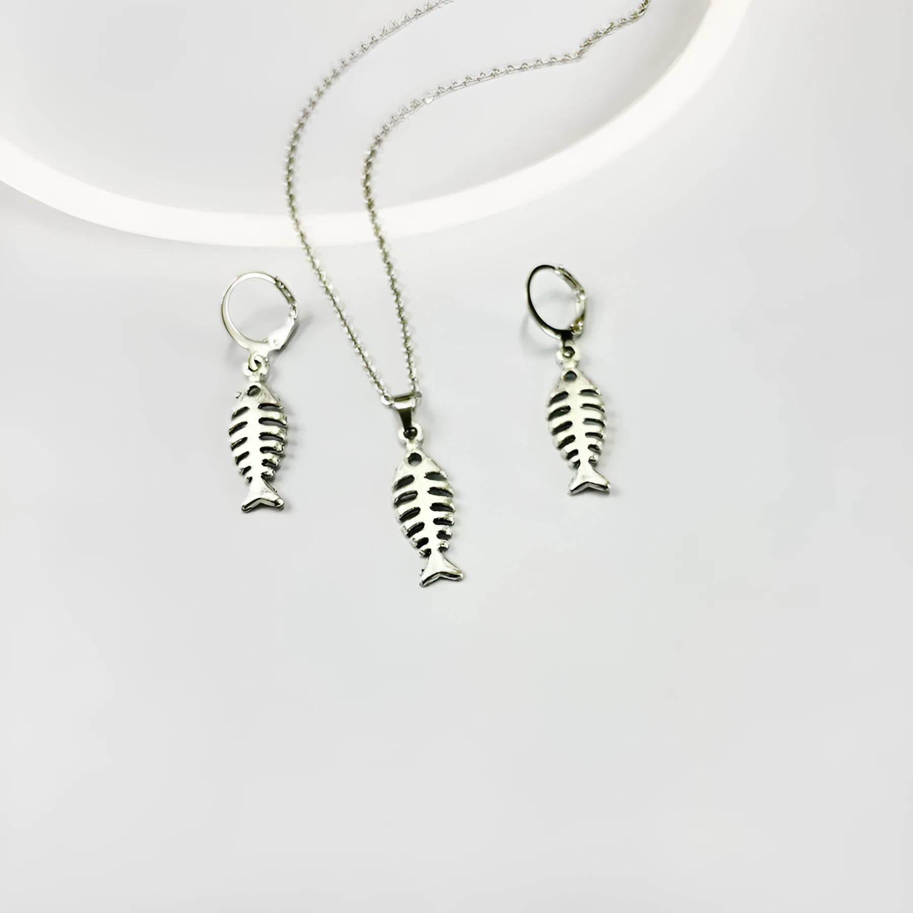 Fishbone pendant necklace and earrings set with adjustable chain on white background