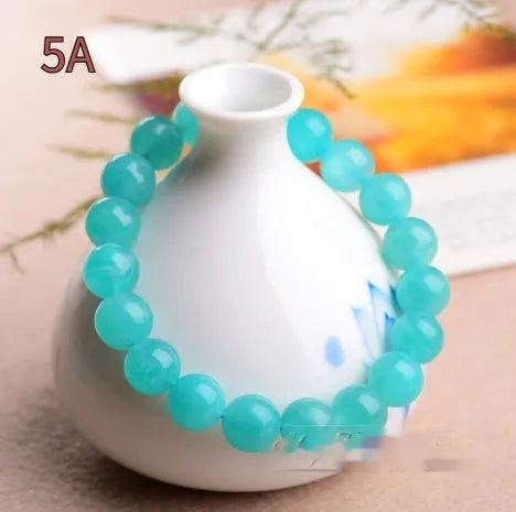 Polished natural Amazonite scattered beads in blue-green ice colours on a white background, showing different sizes from 6mm to 13mm.