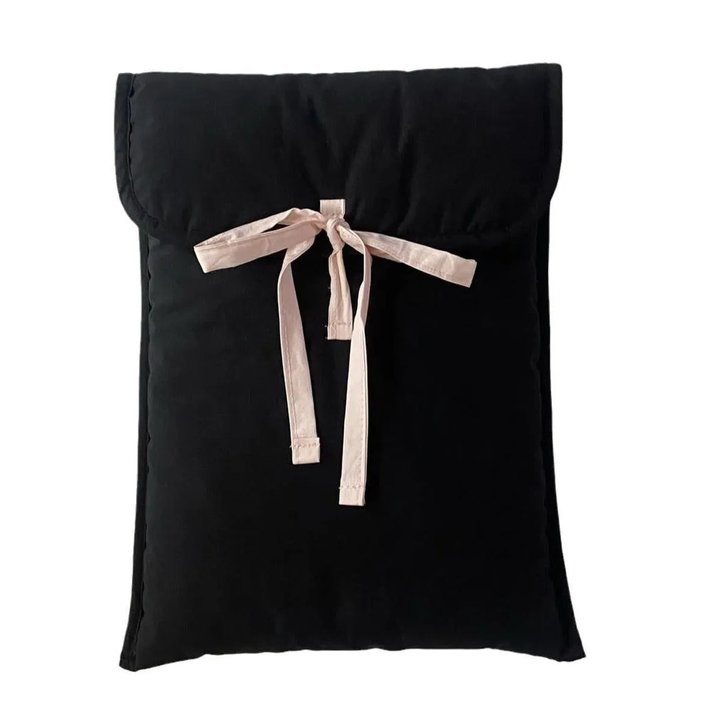 Women's black quilted laptop bag with ballet-style bow detail and striped pattern design