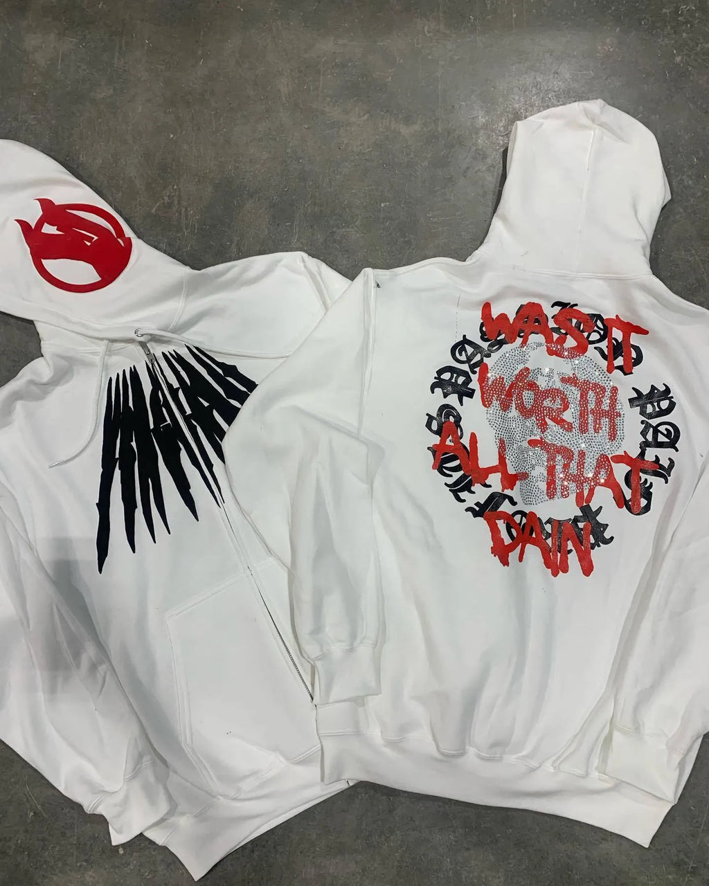 Black loose hooded sweatshirt cardigan with a white printed skull and letter design, featuring rhinestone details.