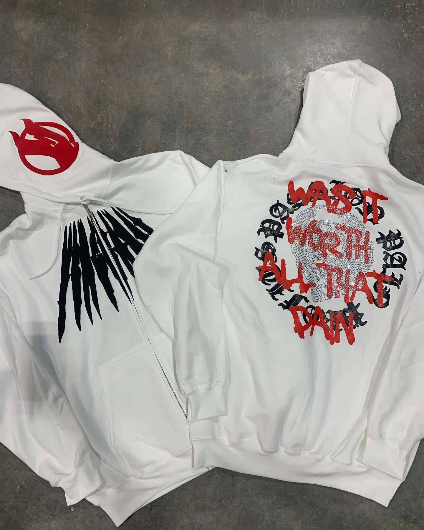 Black loose hooded sweatshirt cardigan with a white printed skull and letter design, featuring rhinestone details.