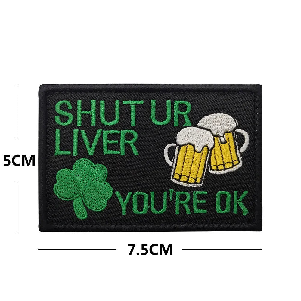 Outdoor embroidered fabric badge with Velcro backing on a tactical vest.