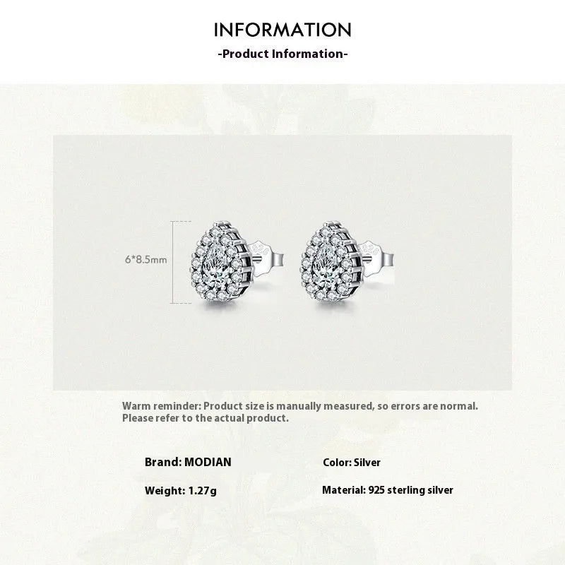 Close-up of a pair of polished silver water drop shaped ear studs on a 925 sterling silver post.