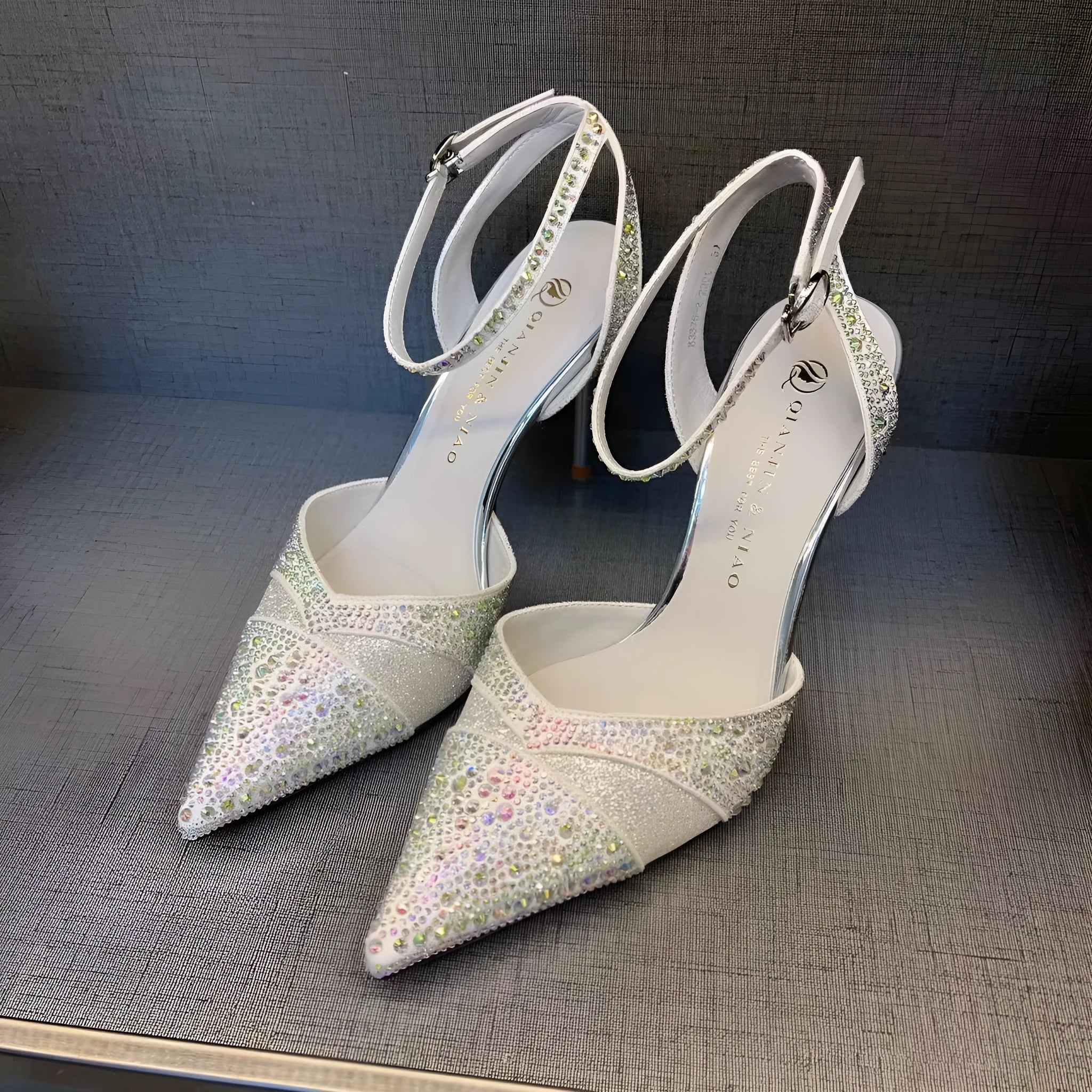 Women's silver and black stiletto heels with red sole and hollow design, pointed toe formal shoes
