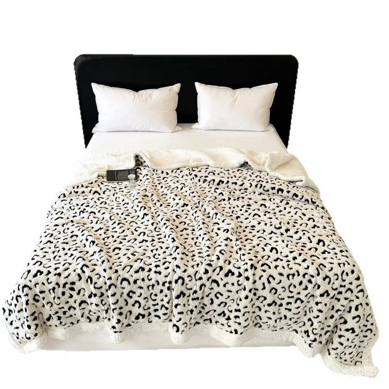 Double-layer cationic leopard jacquard taffeta blanket showing leopard print pattern in camel colour.