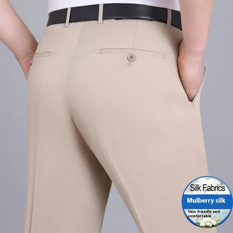 Man wearing black straight-leg high-waisted non-iron business trousers made from a Mulberry Silk blend fabric.