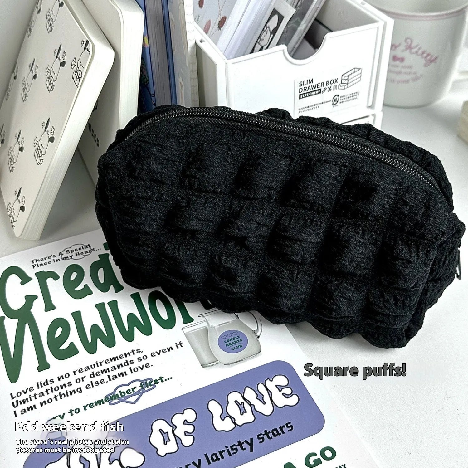 Beige fabric pencil case with cream puff character design and black zip closure
