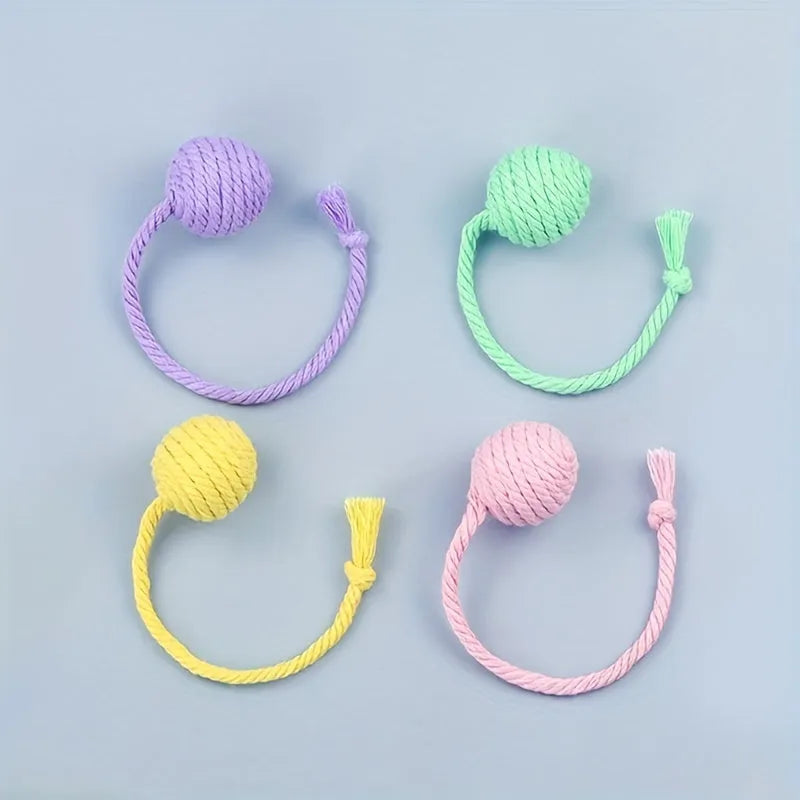 Interactive cat toy ball with rope attachment and built-in bell in green, pink, purple and yellow colours