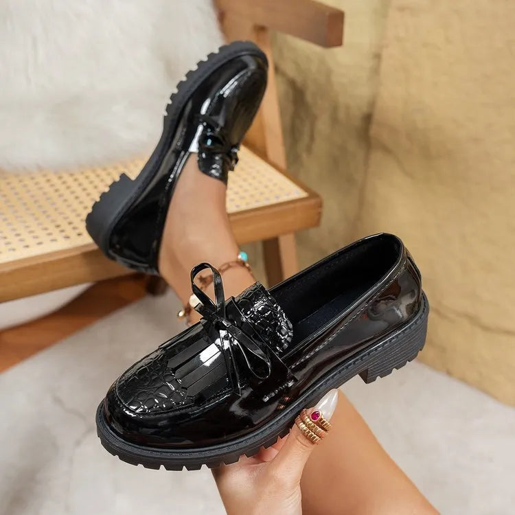 Brown women's loafer with a bow detail on the vamp, made from artificial PU leather.