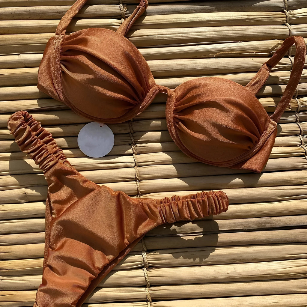 Women's black underwire bikini top and briefs set on a mannequin, showing sleeveless design.