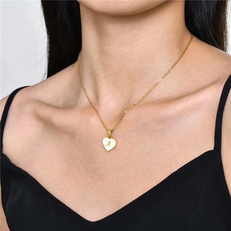 Gold plated heart-shaped white shell pendant personalised initial necklace on a stainless steel chain.
